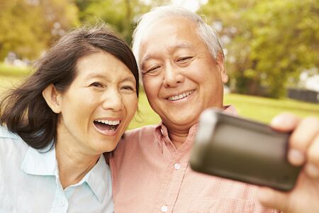 couple with dental implants taking a selfie together