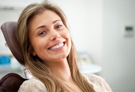 woman smiling after having her wisdom teeth removed